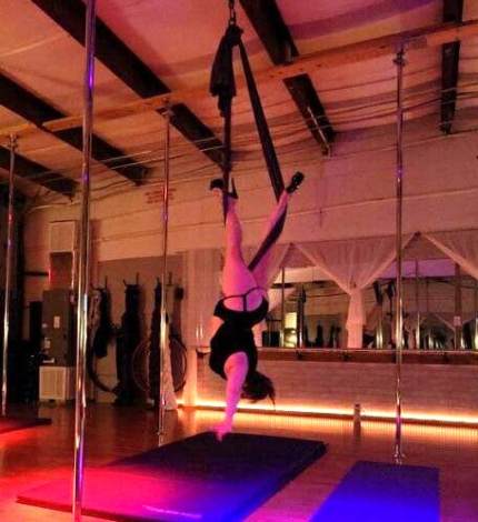 Jennifer performs a pole move at the open house